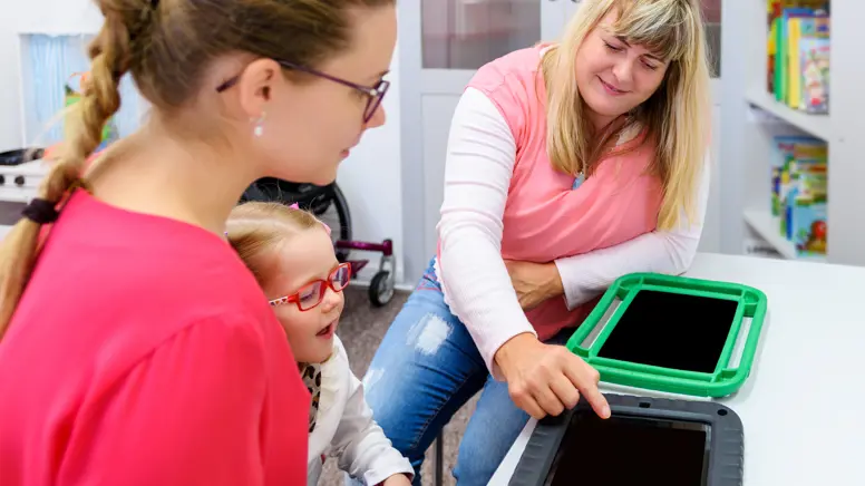 Non Verbal Girl Living With Cerebral Palsy, Learning To Use Digital Tablet Device To Communicate. People Who Have Difficulty Dev